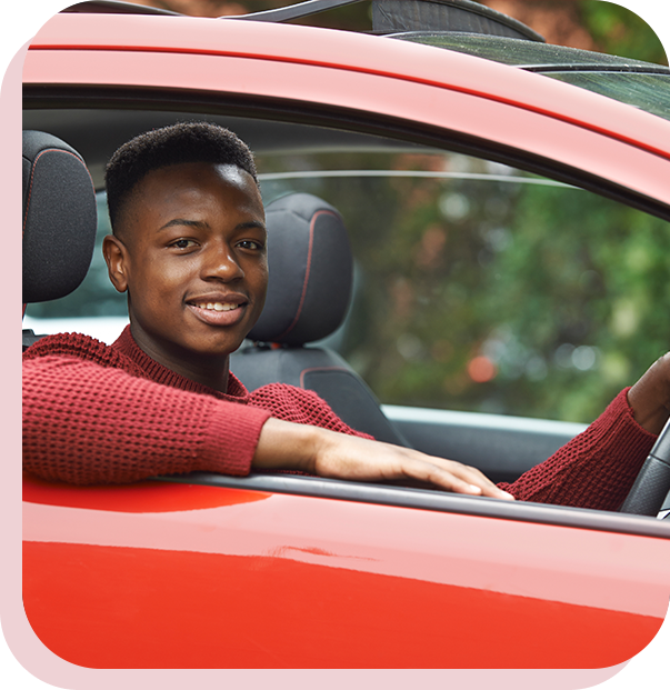 A man sitting in the driver 's seat of his car.